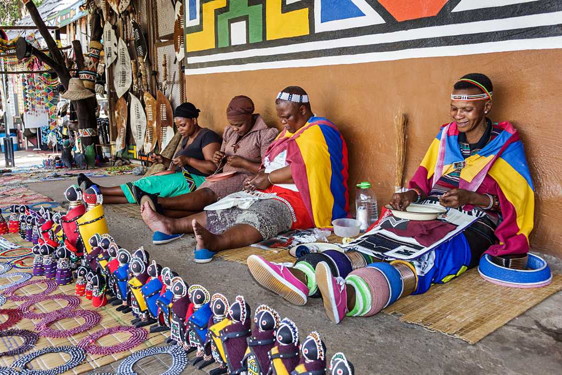 Pedi tribeswoman making beads arts crafts.