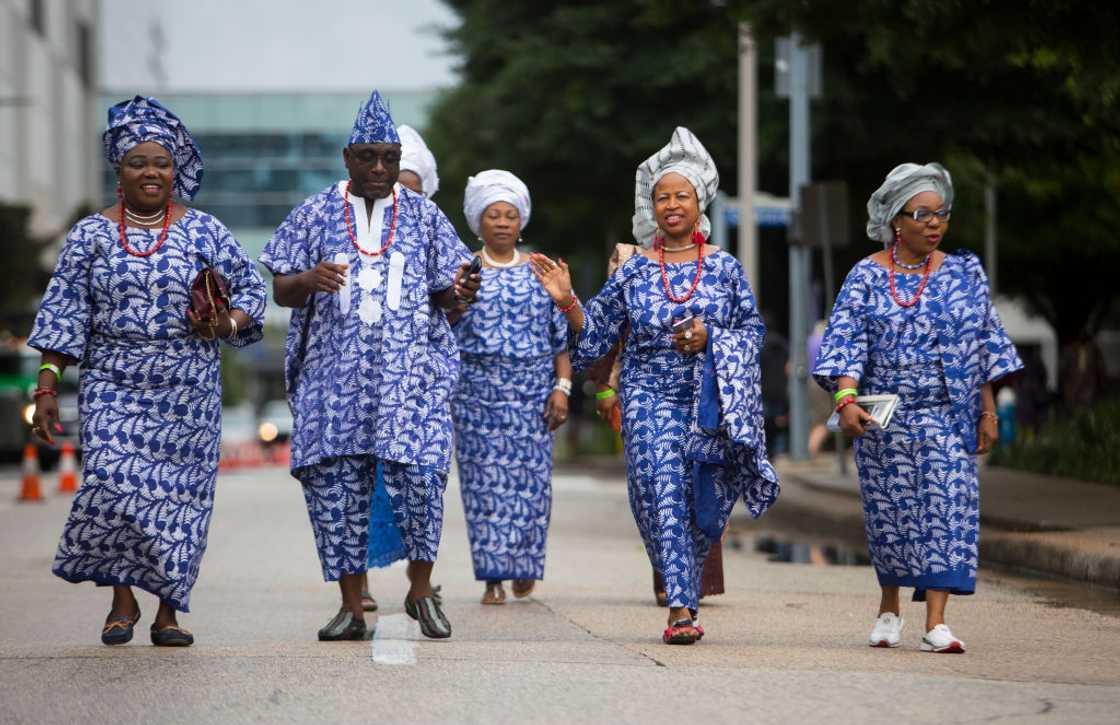 Yoruba tribe members walking in unison.