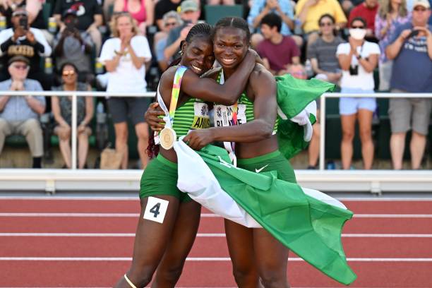 Women's 100m hurdles gold medallist Nigeria's Tobi Amusan (L) hugs women's long jump silver medallist Nigeria's Ese Brume during the World Athletics Championships at Hayward Field in Eugene, Oregon on July 24, 2022. (Photo by ANDREJ ISAKOVIC / AFP) (Photo by ANDREJ ISAKOVIC/AFP via Getty Images)