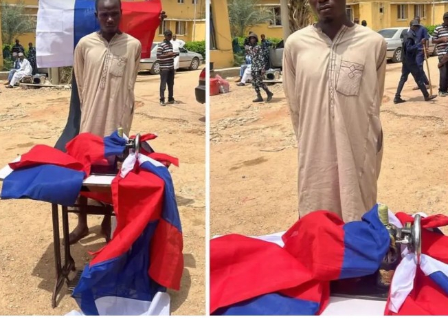 Protest: Tailor sewing Russian flag for protesters arrested in Kano