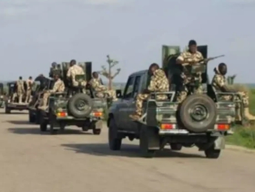 Policemen, soldiers escorting construction workers