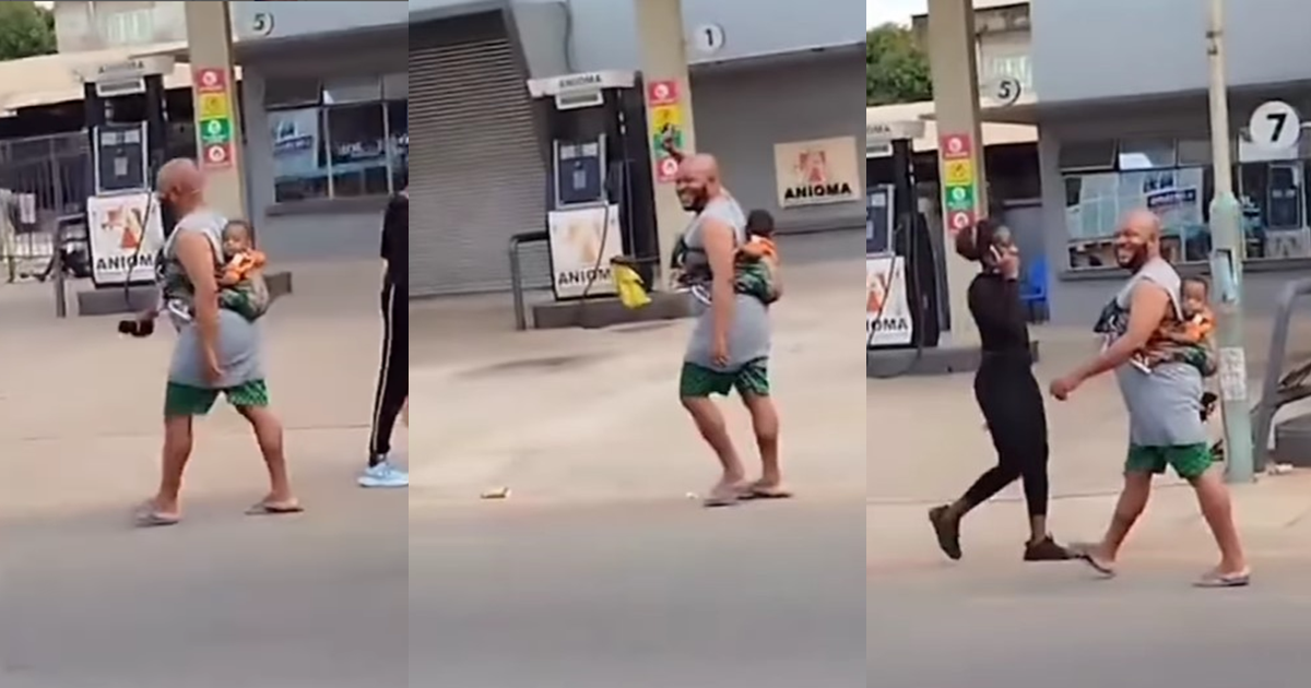 "Husband material" – Man spotted joyfully strolling with a child on his back in Onitsha (WATCH)