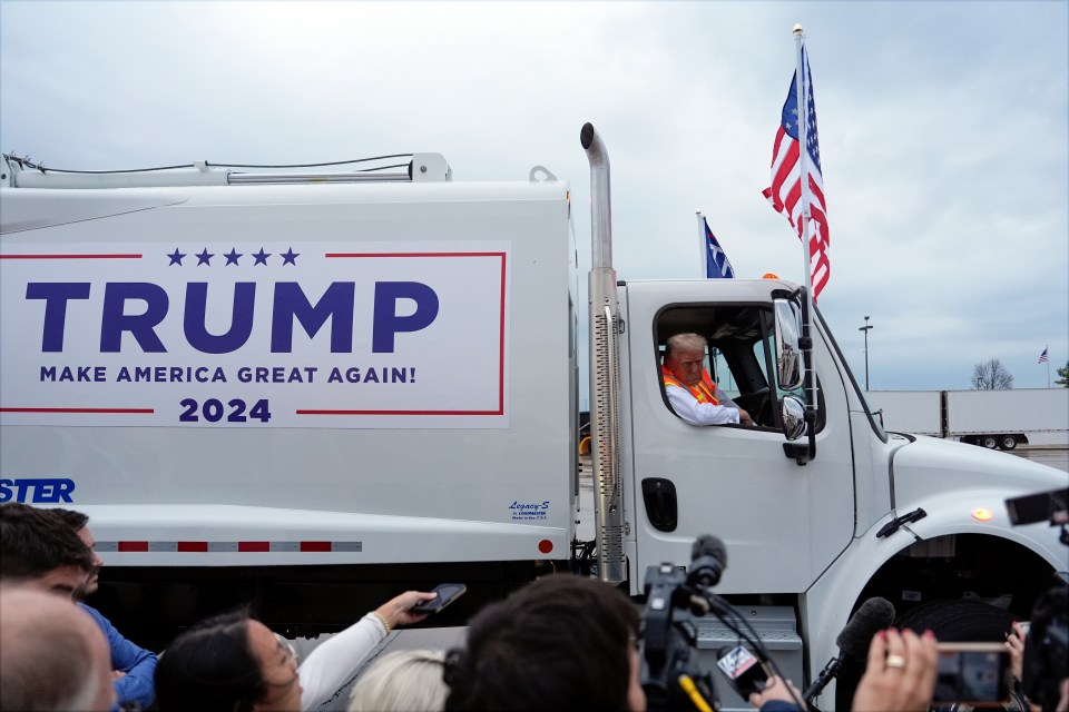 The presidential nominee addressed a crowd of fans and reporters from inside the motor which was branded in US flags and a Trump 2024 banner