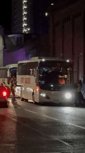 Police were seen surrounding a supporters' bus during a heated exchange