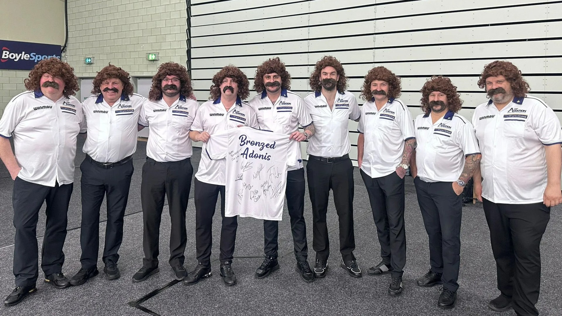 Darts stars all dress up as cult hero 'Bronzed Adonis' before his final Players Championship… how many can you name?