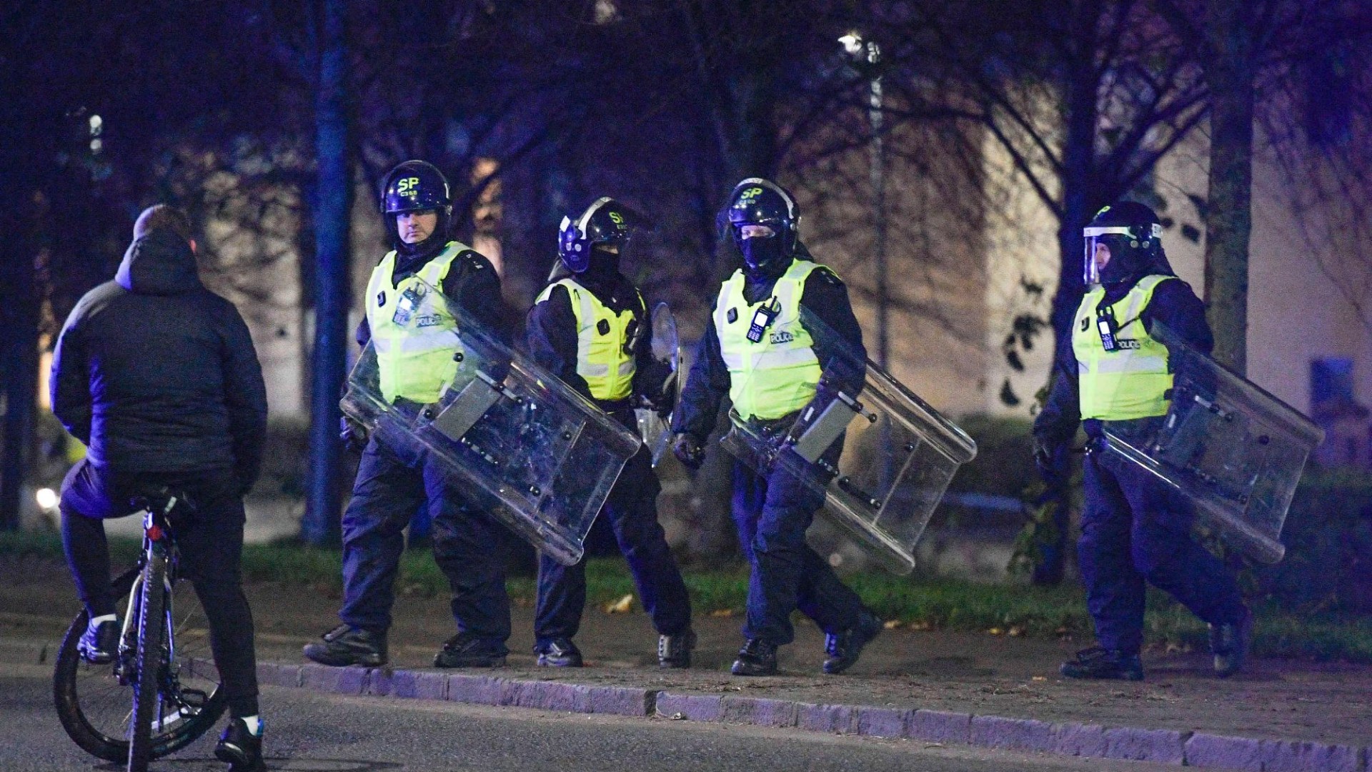 Riot cops clash with firework yobs and police chopper called in as gangs torch bins & launch bottles