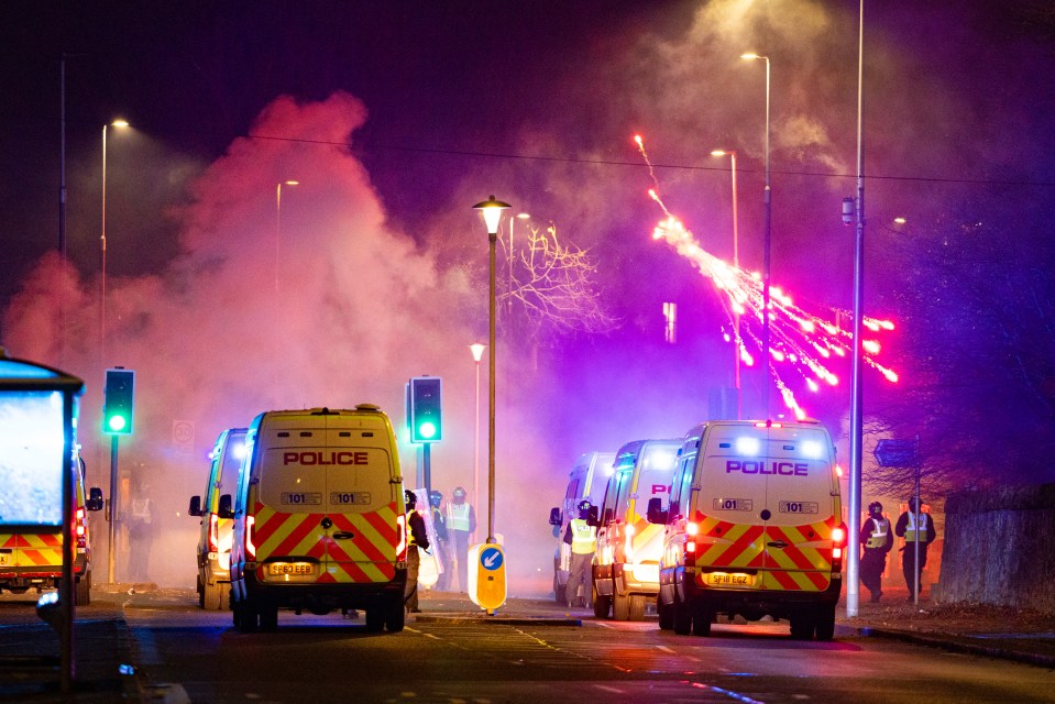 Police were pelted with fireworks as yobs launched rockets towards the vehciles