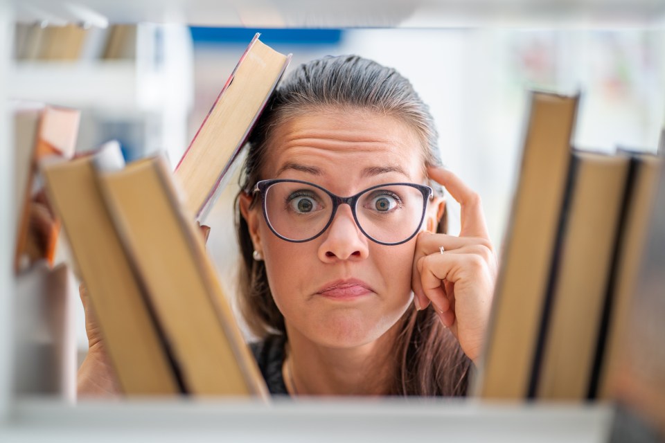 Portrait of Forgetful Young Woman in Library.