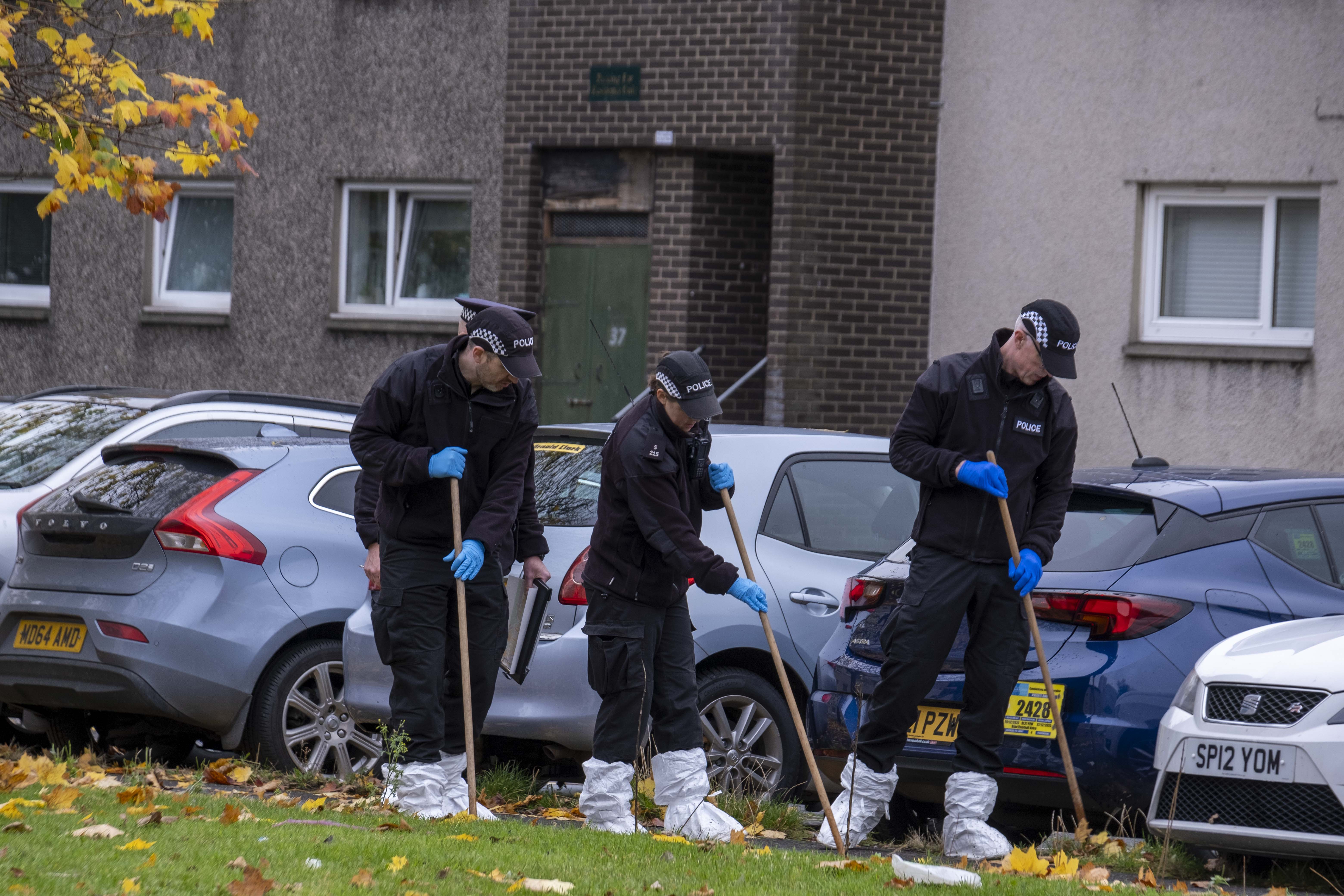 Police officers scoured the Glasgow crime scene in a bid to nail the suspect