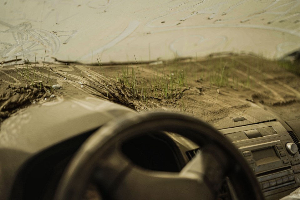 One car even has grass spouting out the dashboard from the mud