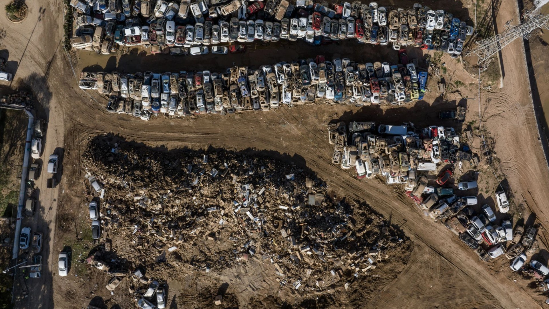 Horror pics show car graveyard in Spain with piles of wrecked & mud-caked motors after floods that killed more than 200