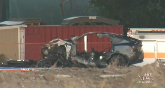 The burnt-out wreckage of the crashed Tesla