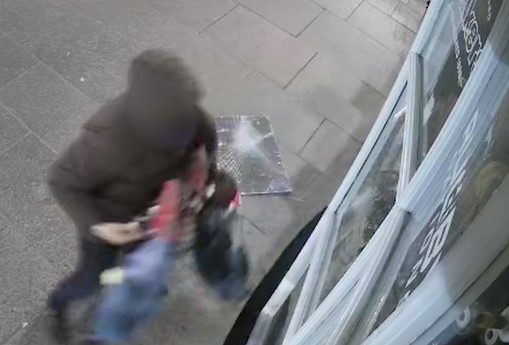 CCTV images capture the moment the thief flees with an armful of loot