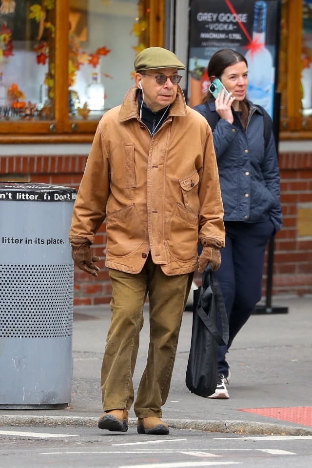 The actor kept warm in a brown jacket and cap