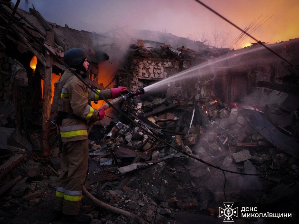 The site of a blast in Mykolaiv - one of the worst hit regions - as a firefighter works to put out flames