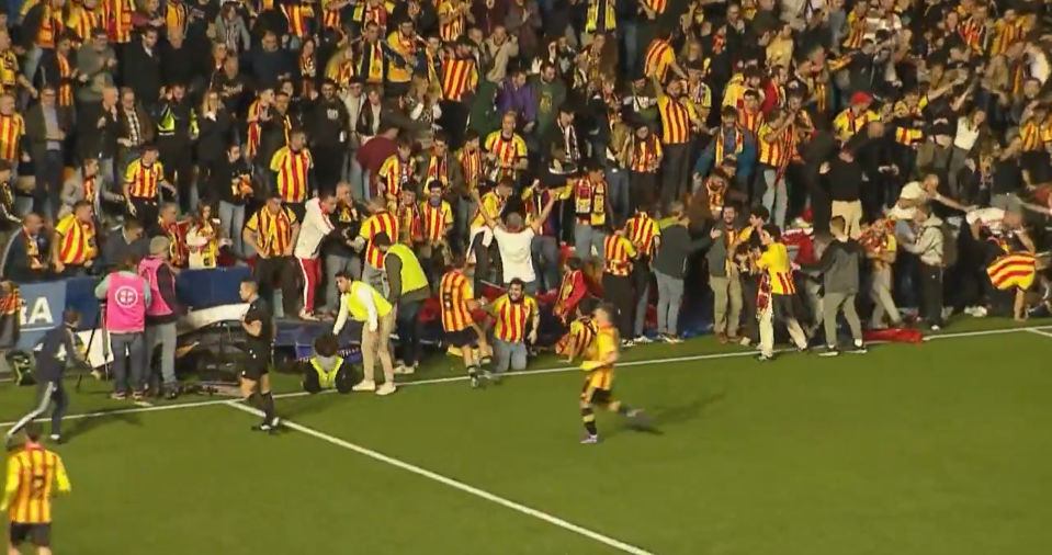 Supporters tumbled onto the pitch in the Catalan derby