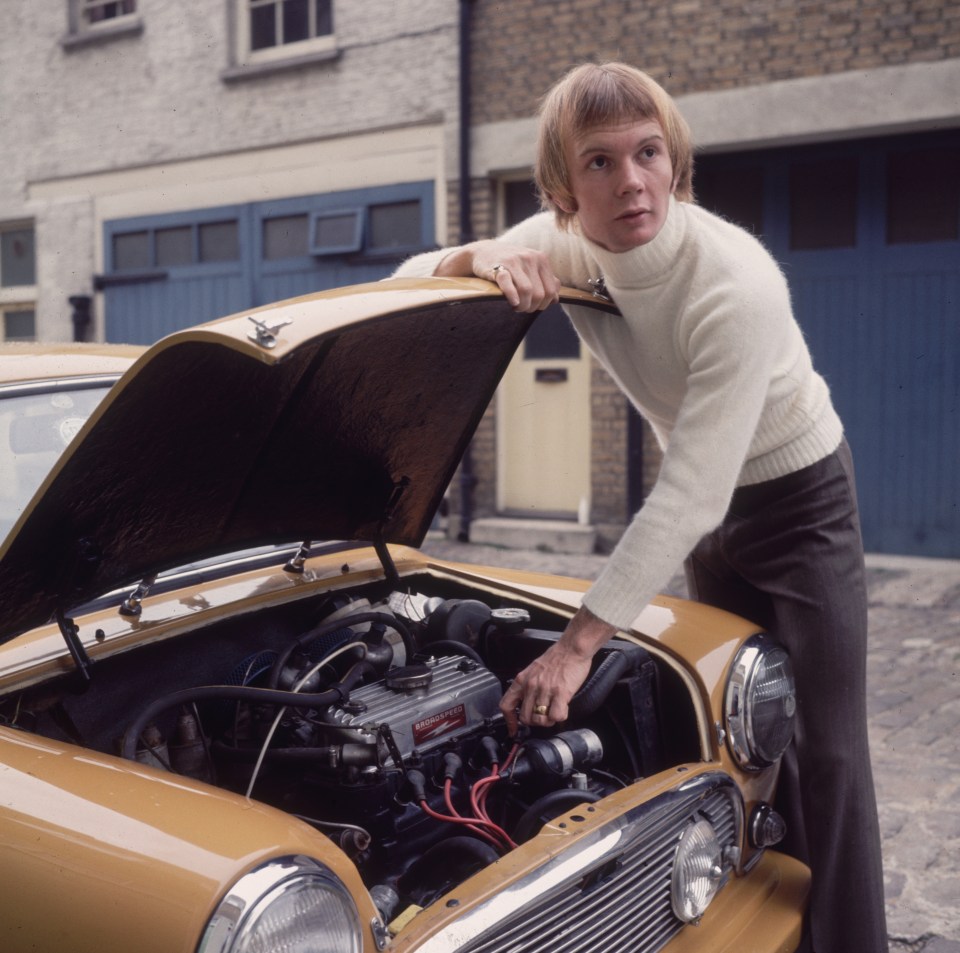 Petersen tinkering under the bonnet of his car