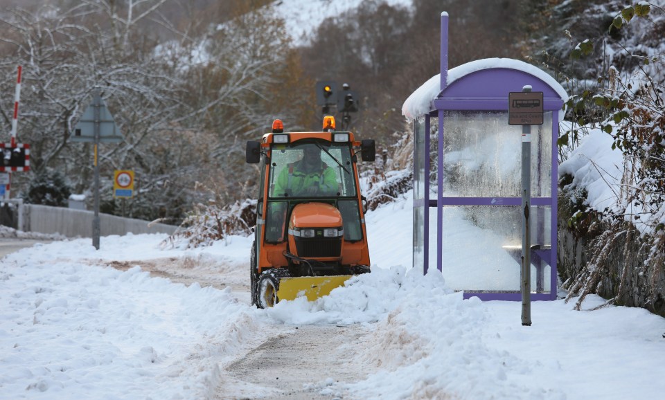 A workman clears snow from the pavements in the village of Garve in Ross-shire