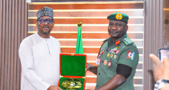 R-L: Chief of Defence Staff, General Christopher Musa, presenting gift to chairman, National Sports Commission, Shehu Dikko during a visit to the Defence Headquarters in Abuja, yesterday.