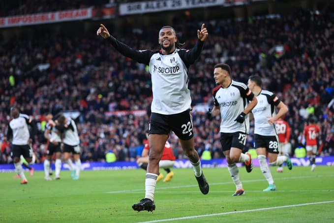 Alex Iwobi celebrates after scoring against Manchester United at Old Trafford.