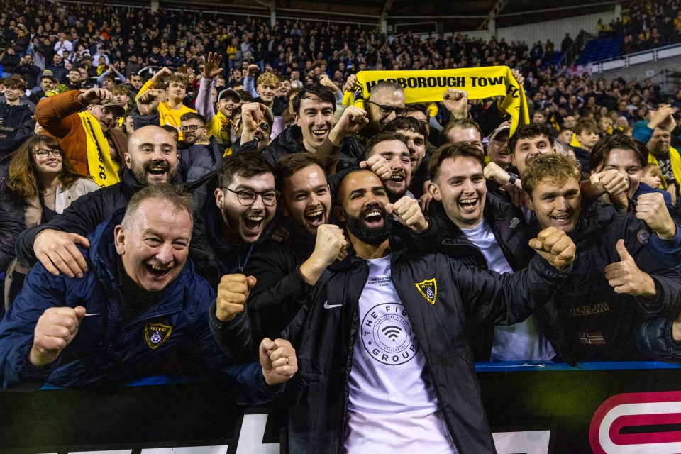 Former Tottenham favourite Sandro poses with Harborough Town fans in the stands