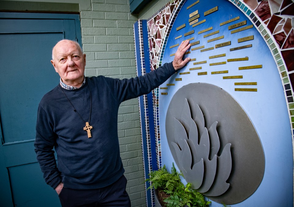 Canon John Ellis with the Shalom Youth Club memorial to young former members