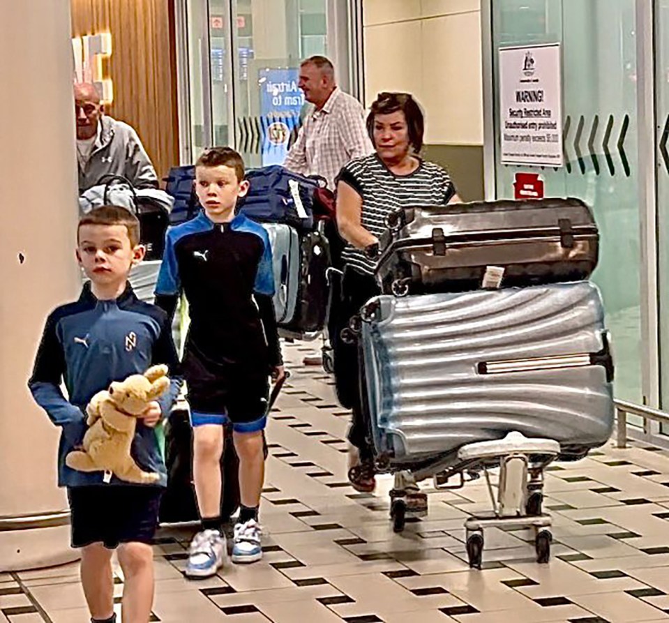 Tony and Colette McLoughlin arriving at Brisbane Airport last week with Cass and Kit