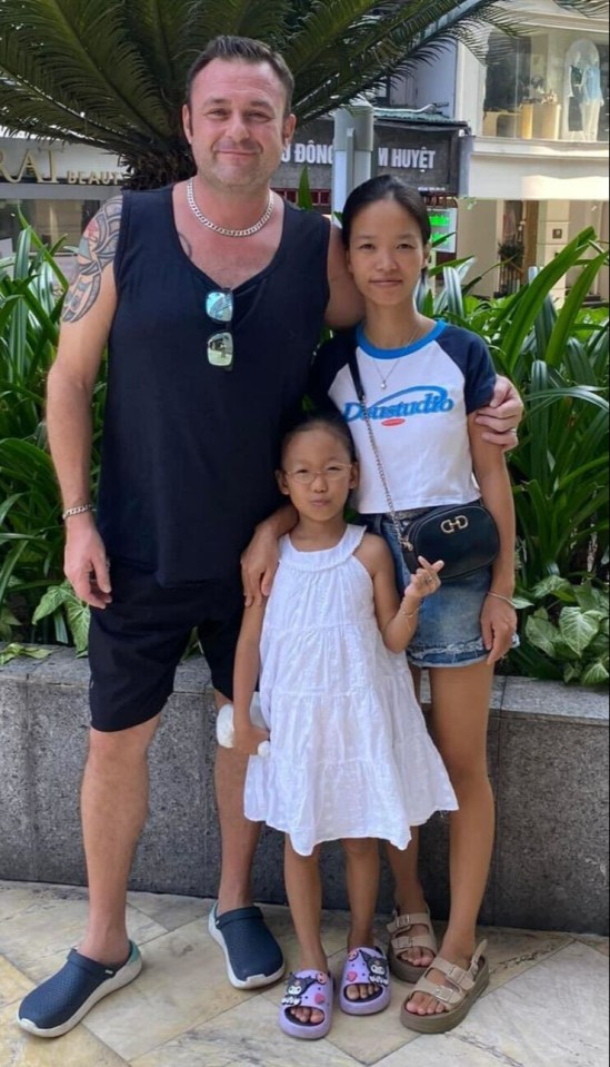 Allan Kato, 48, with his wife and eight-year-old stepdaughter