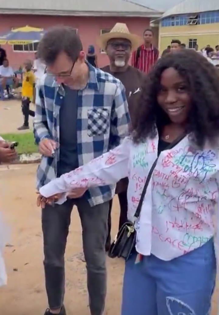 Lady excited as her Caucasian man flies from US to attend her sign-out