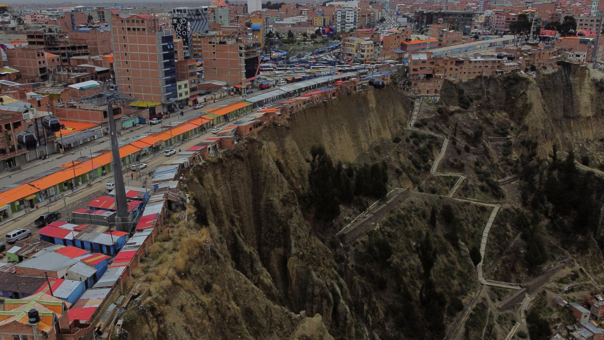 World’s scariest street of ‘suicide homes’ inches away from plunging onto razor rocks down 200ft cliff…which is ERODING