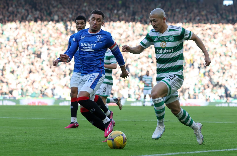 Daizen Maeda of Celtic runs with the ball while under pressure by James Tavernier