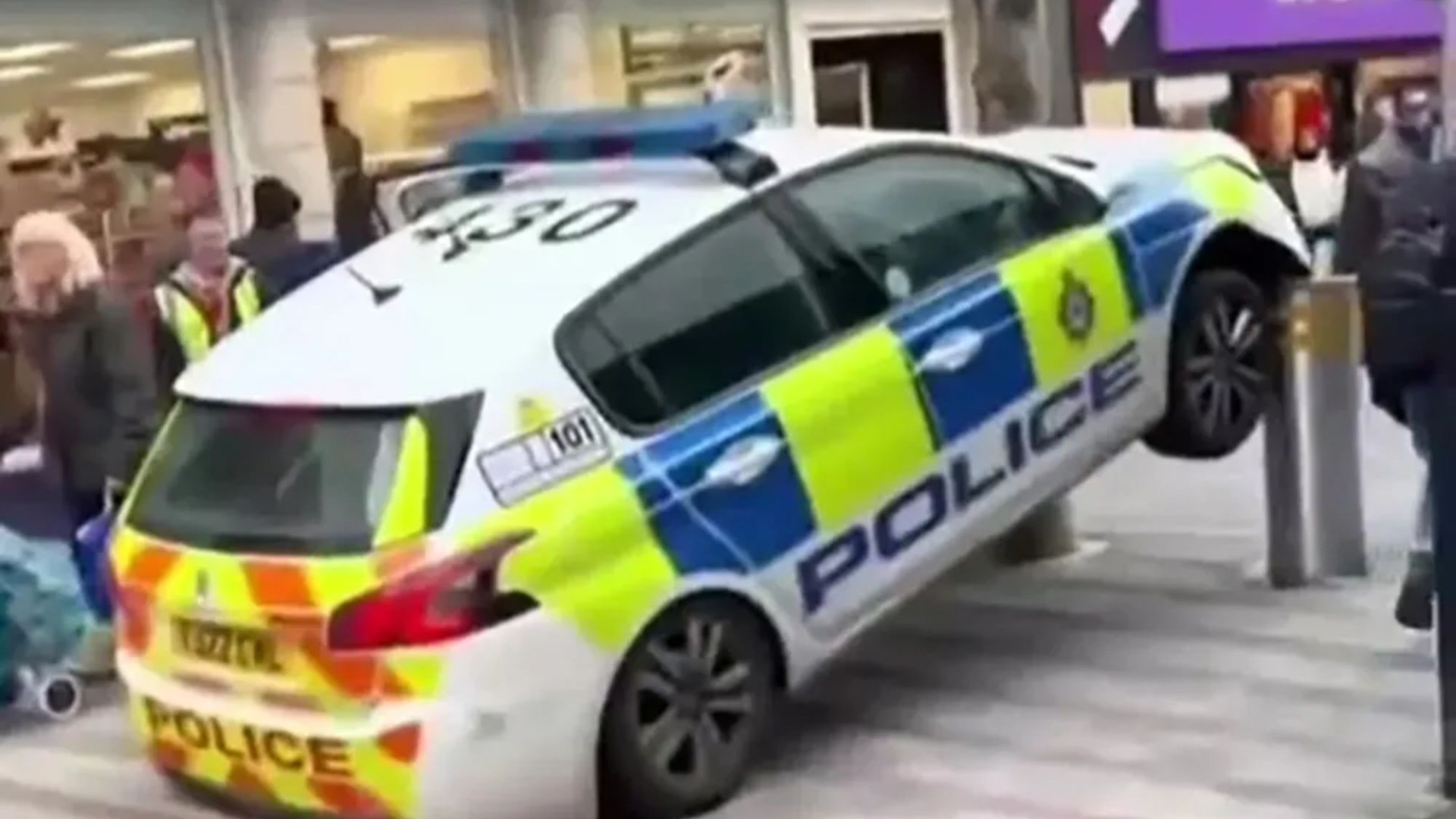 Hilarious moment police car is lifted into the air by faulty security bollards - with two cops stuck inside