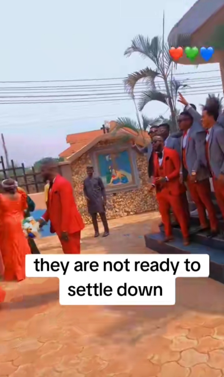 Moment groomsmen run away as groom throws wedding flower at them