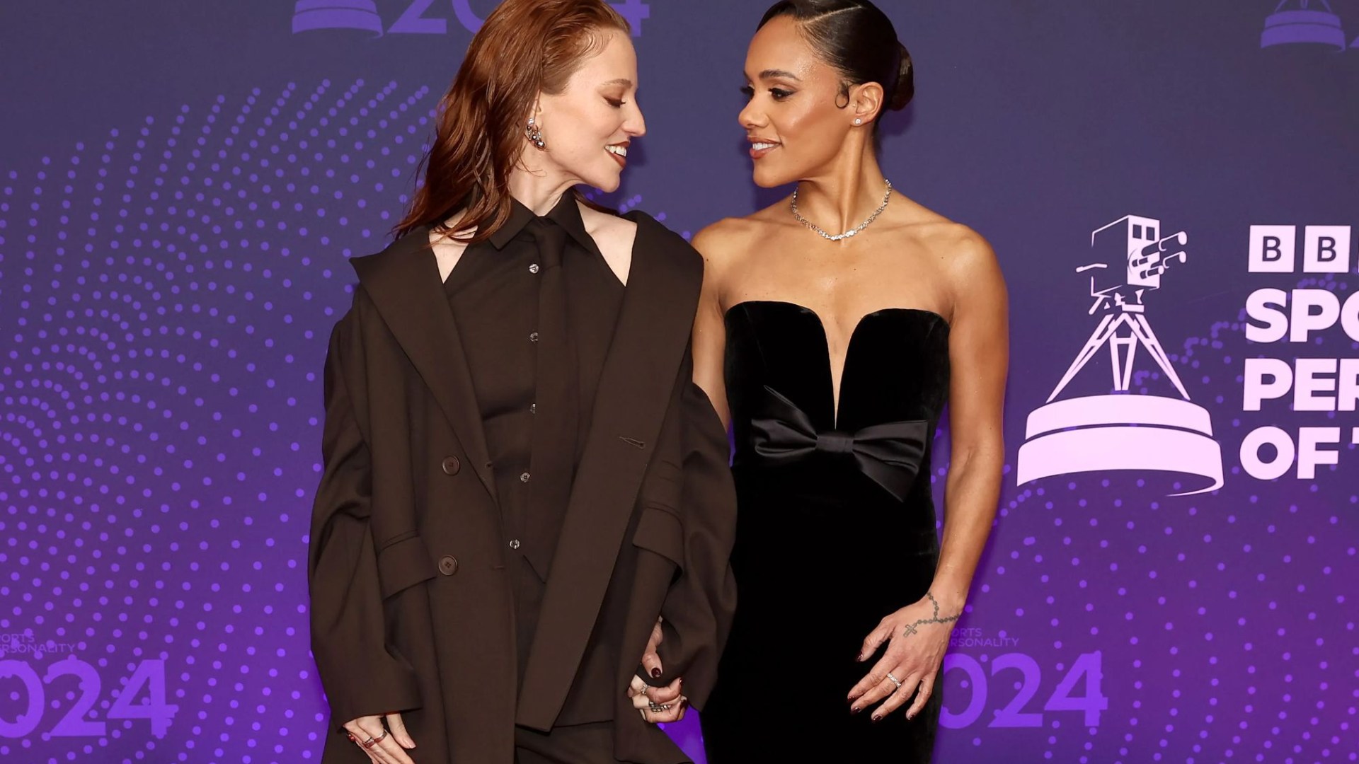 Alex Scott gets some help fixing stunning strapless dress from partner Jess Glynne on SPOTY red carpet