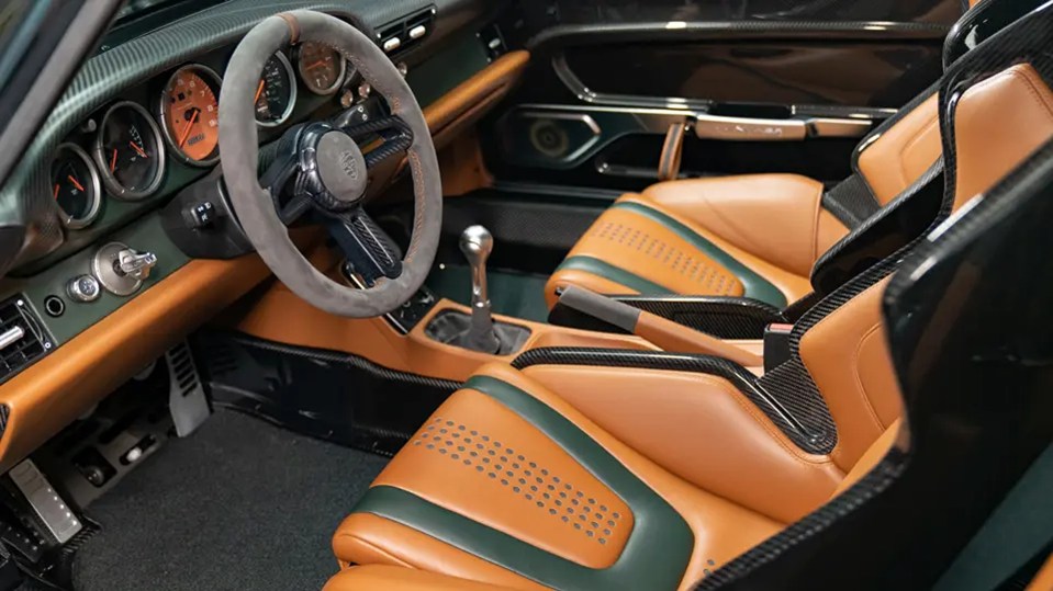 The car's interior is black and tan leather