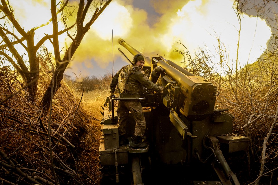 A Ukrainian serviceman firing at Russian soldiers