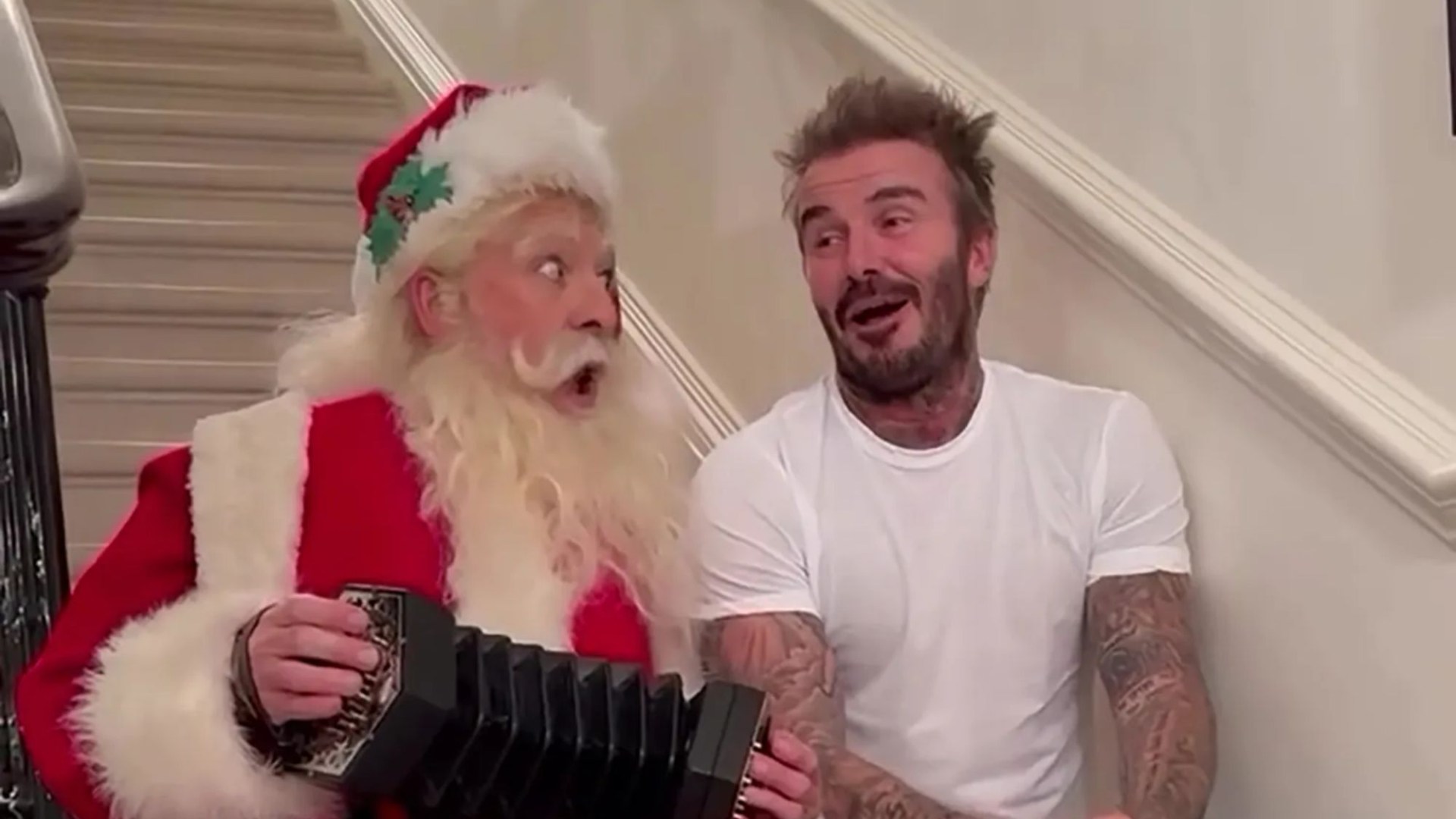 Watch as David Beckham invites Santa into his London home for a festive Christmas Day singalong