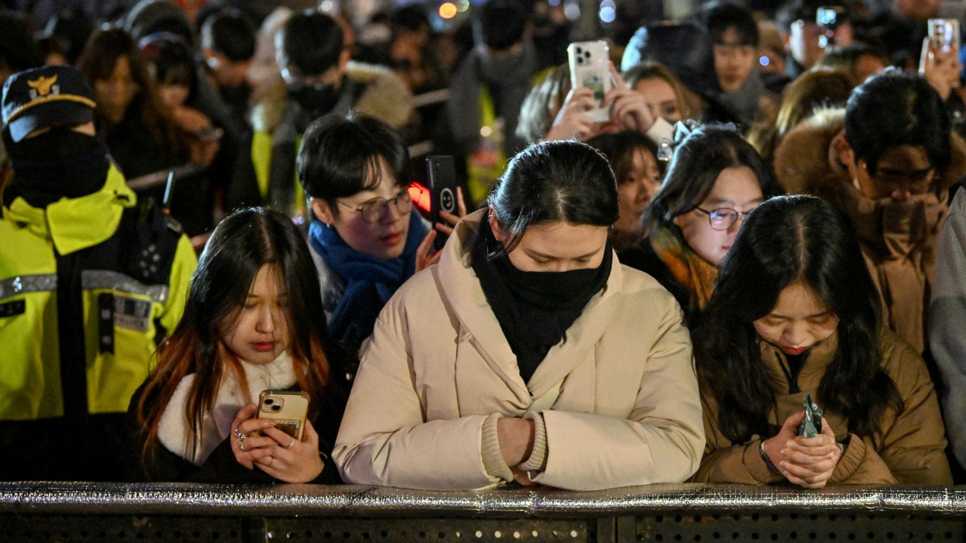 Watch haunting moment mourning South Korea marks New Year with SILENT crowds after plane disaster and ‘coup’ drama