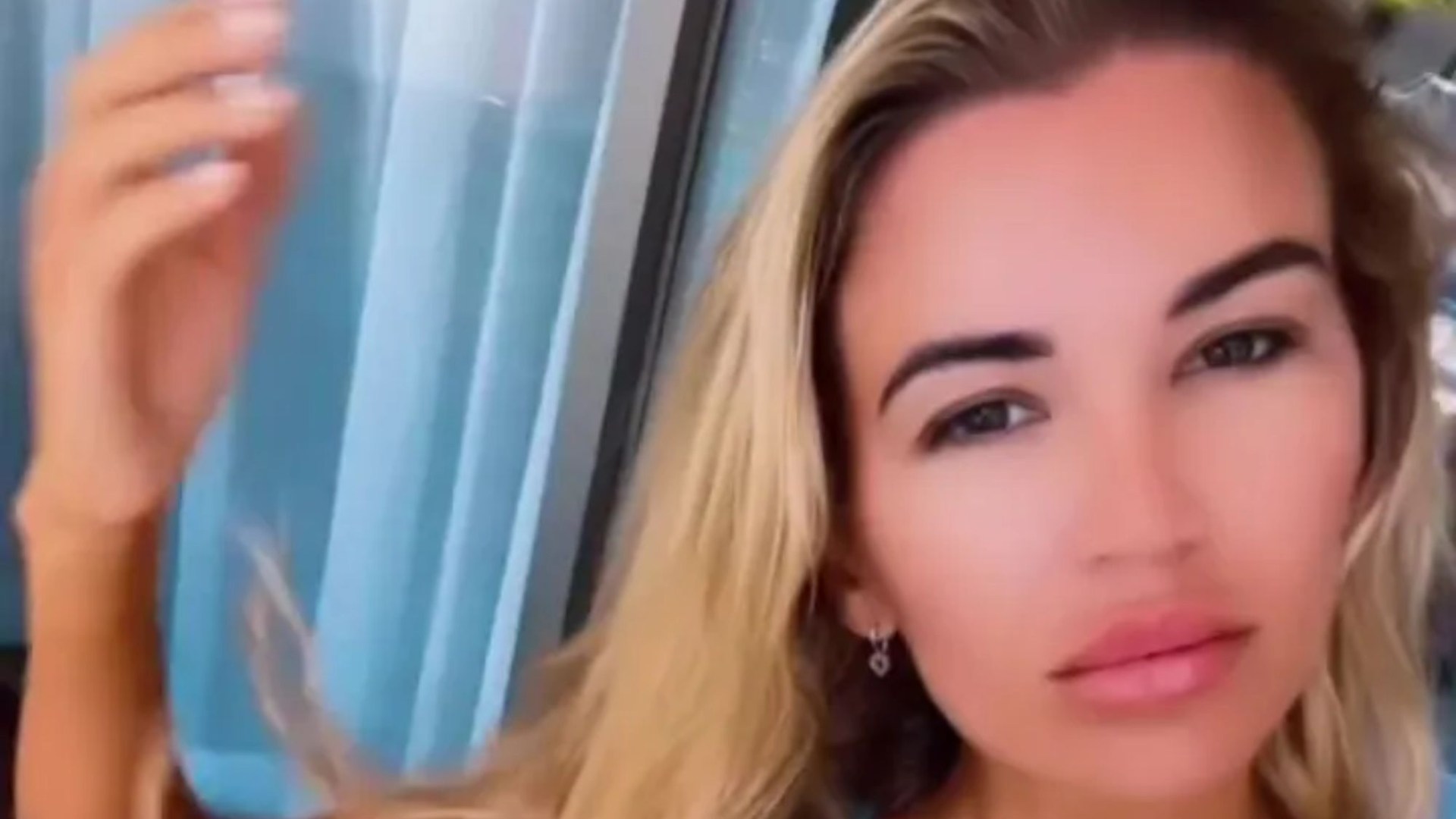 Christine McGuinness wears nothing but a tiny thong as she strips topless in new video