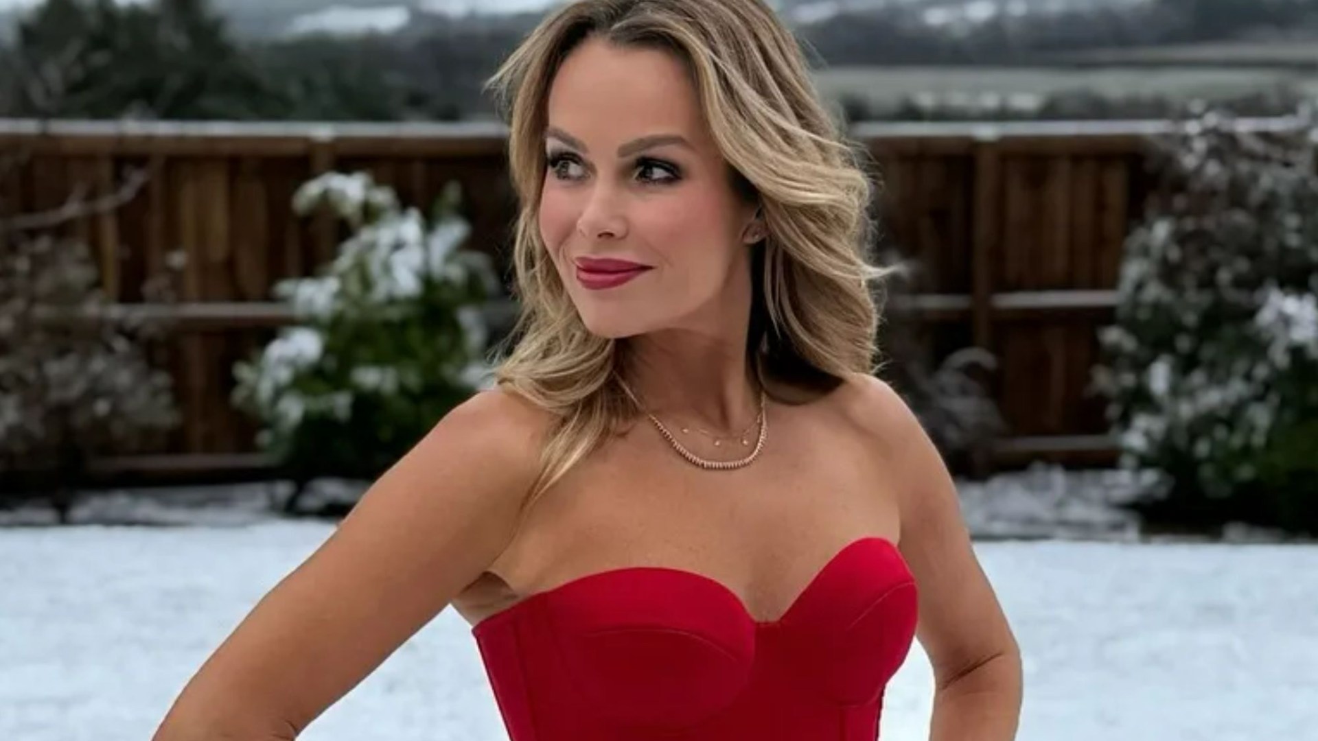 Amanda Holden wears red corset top and tartan skirt for photos in the snow on New Year's Day